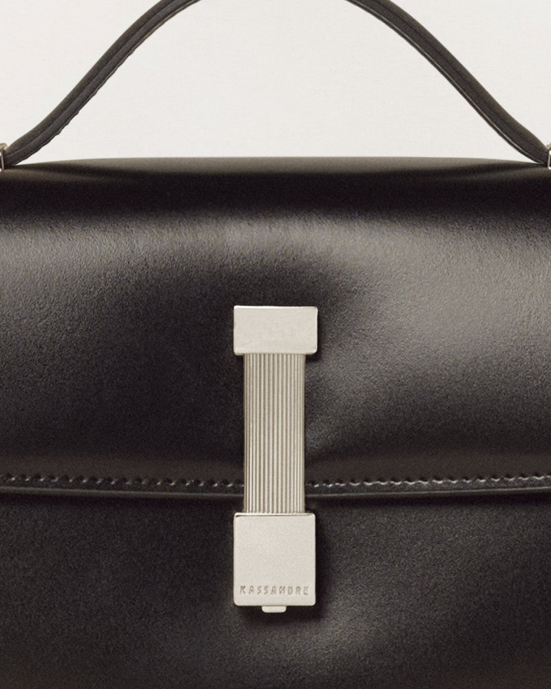 Kassandre Colonne clutch in black cow leather with silver hardware, rigorous lines, detail view