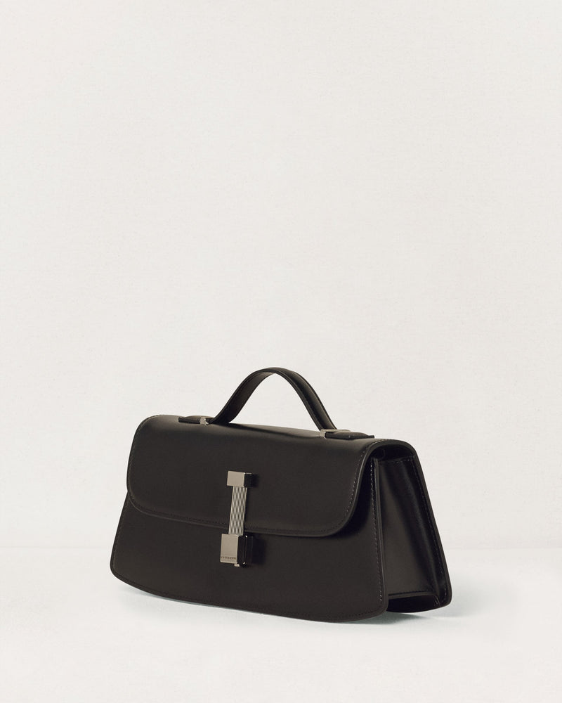 Kassandre Colonne clutch in black cow leather with silver hardware, rigorous lines, three quarter view
