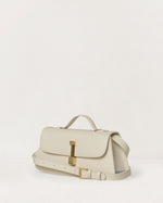 Kassandre Colonne clutch in off-white cow leather with gold hardware, rigorous lines, adjustable removable strap ,crossbody bag, three quarter view