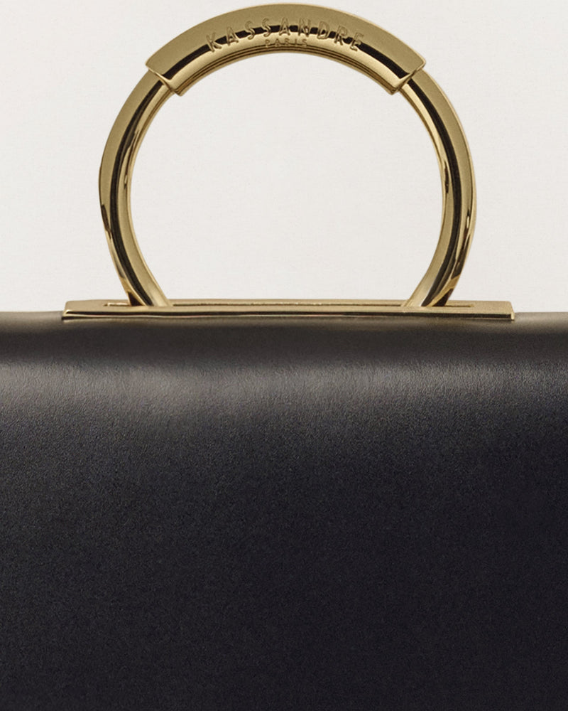 Kassandre Deva clutch in black cow leather with gold hardware, Art Deco geometry,removable strap , crossbody bag , detail view