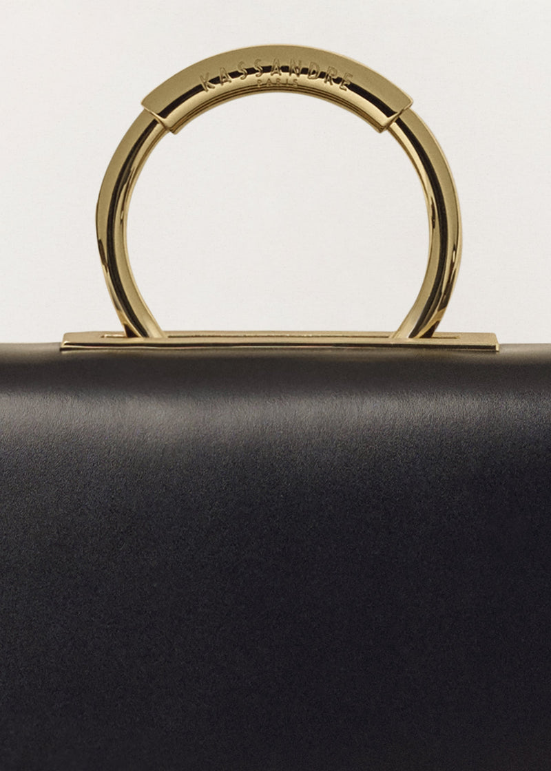 Kassandre Deva clutch in black cow leather with gold hardware, Art Deco geometry,removable strap , crossbody bag , detail view