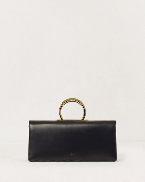 Kassandre Deva clutch in black cow leather with gold hardware, Art Deco geometry, removable strap , crossbody bag , front view