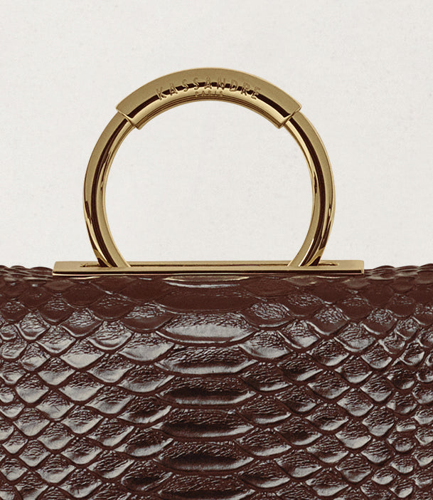 Kassandre Deva clutch in brown python-effect leather, sculptural Art Deco geometry, removable strap , crossbody bag ,detail view