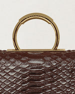 Kassandre Deva clutch in brown python-effect leather, sculptural Art Deco geometry, removable strap , crossbody bag ,detail view