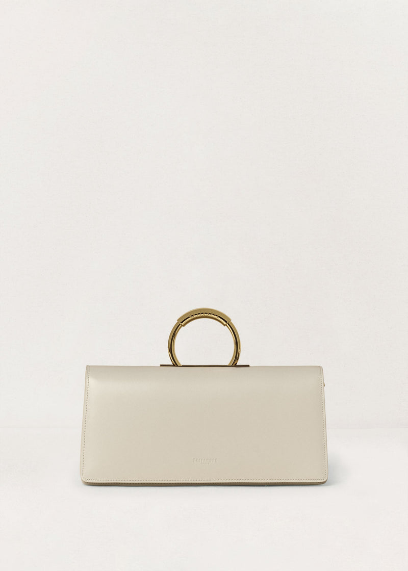 Kassandre Deva clutch in off-white cow leather, pure geometric form, adjustable strap, removable strap , crossbody bag ,front view