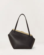 Kassandre Eileen asymmetric shoulder bag in black cow leather, architectural line, gold frame, back view