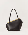 Kassandre Eileen asymmetric shoulder bag in black cow leather, architectural line, front view