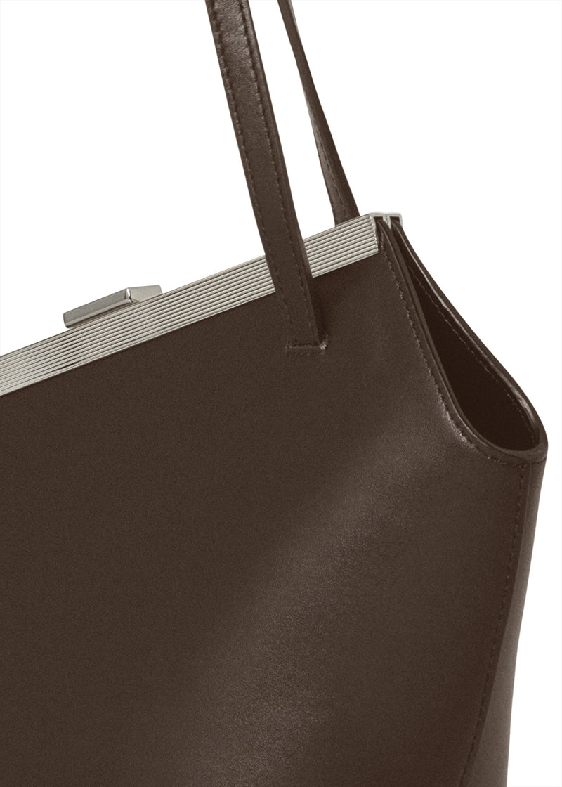 Kassandre Eileen asymmetric shoulder bag in brown cow leather, silver frame, graphic geometry, detail view