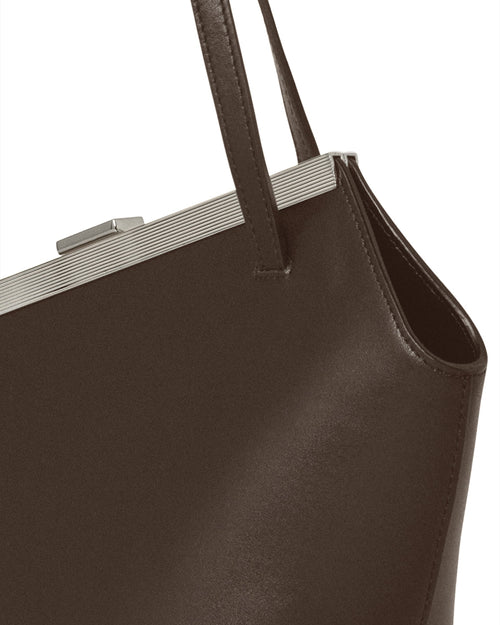 Kassandre Eileen asymmetric shoulder bag in brown cow leather, silver frame, graphic geometry, detail view