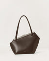 Kassandre Eileen asymmetric shoulder bag in brown cow leather, silver frame, graphic geometry, front view