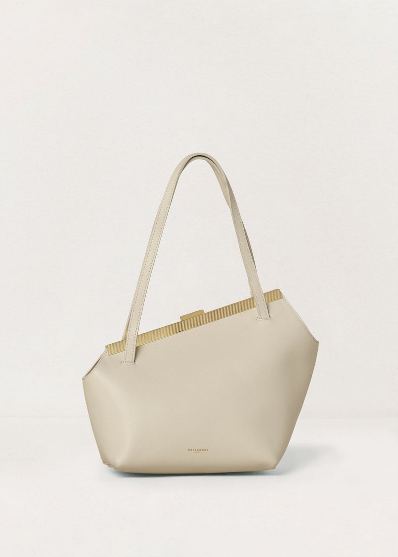 Kassandre Eileen asymmetric shoulder bag in off-white cow leather, clean line, gold frame, front view