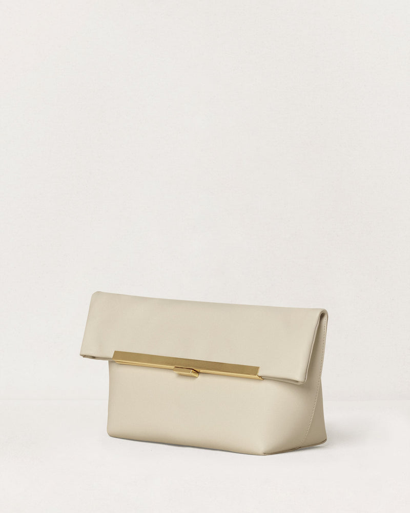 Kassandre Eileen clutch in off-white cow leather with gold metal frame, Art Deco lines , three quarter view