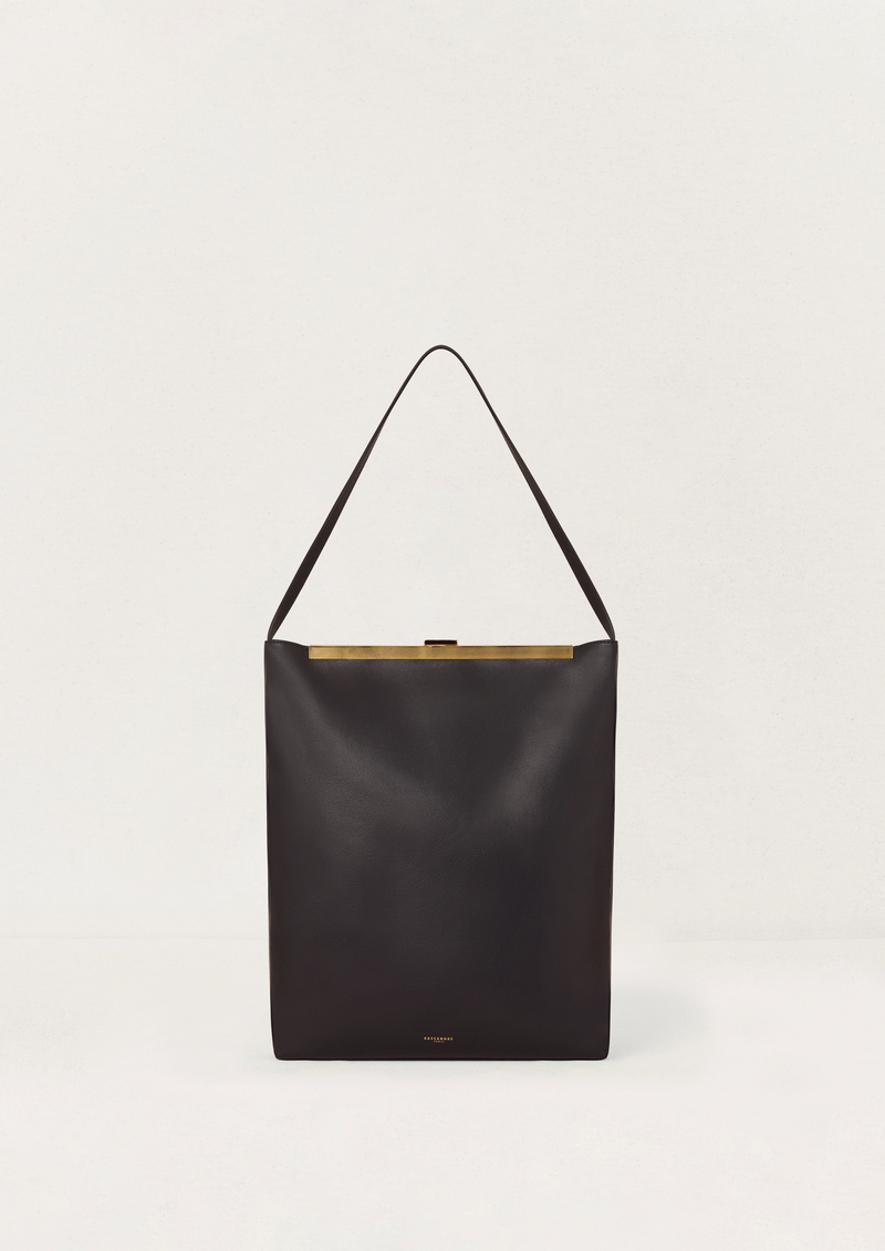 Kassandre Eileen computer bag in black cow leather with gold striped metal frame, front view
