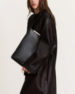 Kassandre Eileen computer bag in black cow leather with gold striped metal frame, video