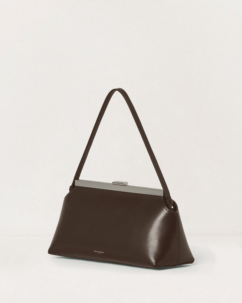 Kassandre Eileen shoulder bag in brown smooth cow leather with striped metal frame, three quarter view