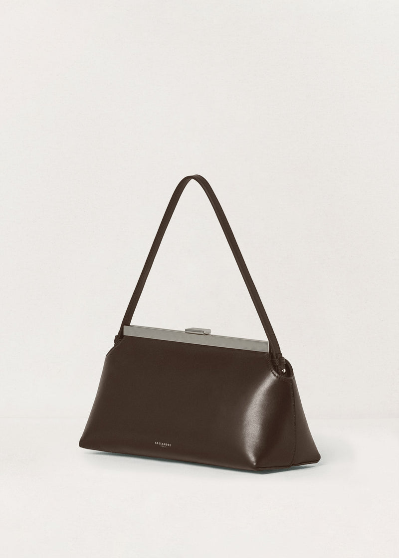 Kassandre Eileen shoulder bag in brown smooth cow leather with striped metal frame, three quarter view