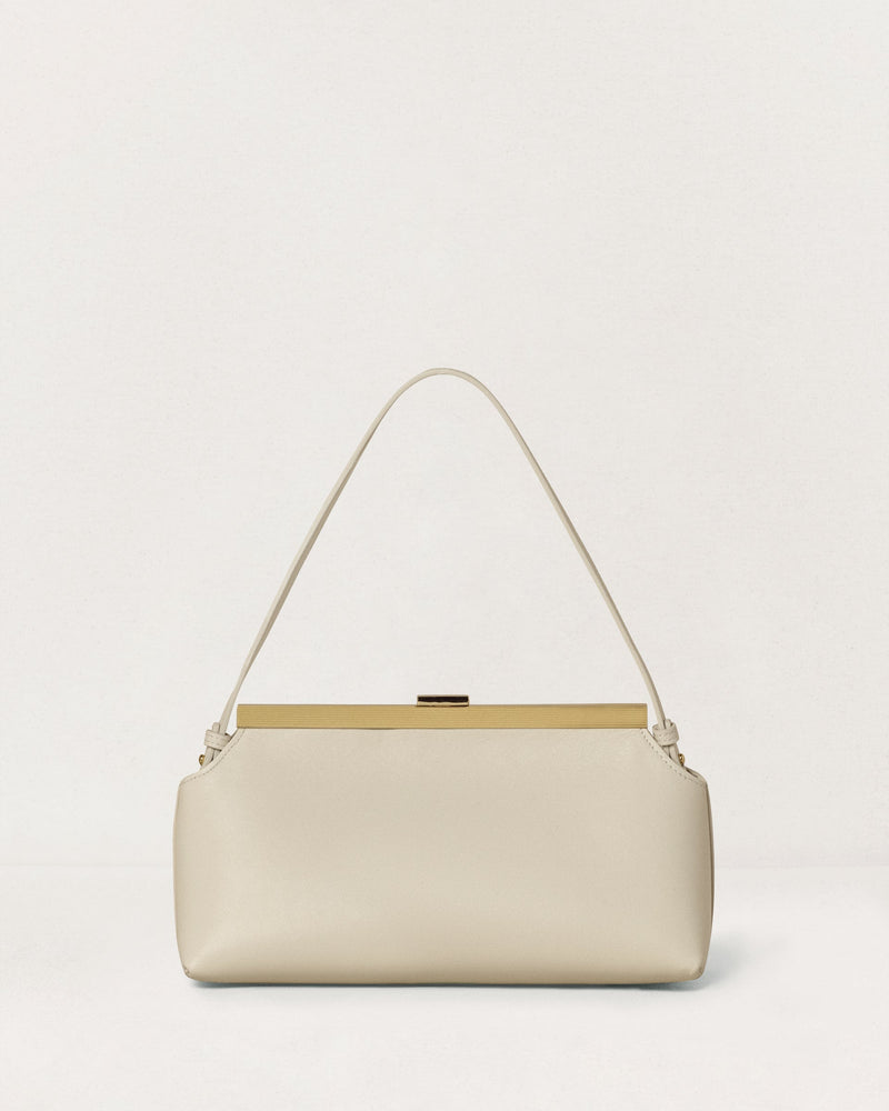 Kassandre Eileen shoulder bag in off-white cow leather with gold striped metal frame, back view